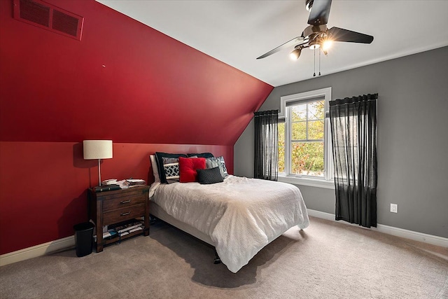 carpeted bedroom featuring lofted ceiling, ceiling fan, visible vents, and baseboards