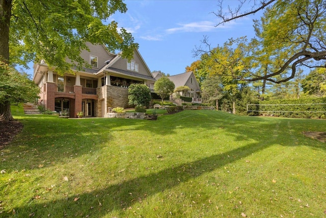 view of yard with a balcony and volleyball court