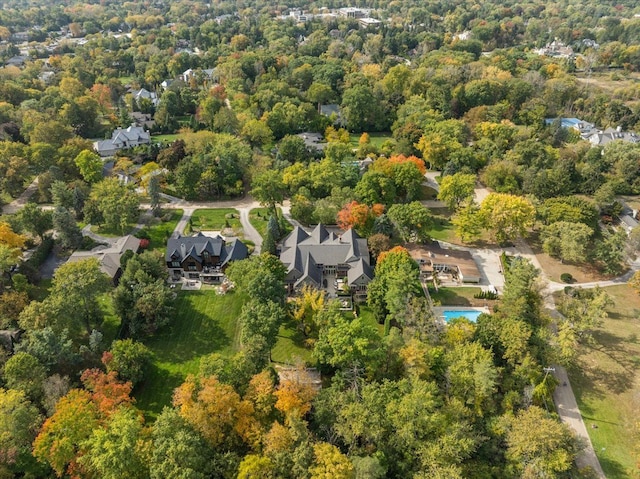 drone / aerial view featuring a residential view and a wooded view