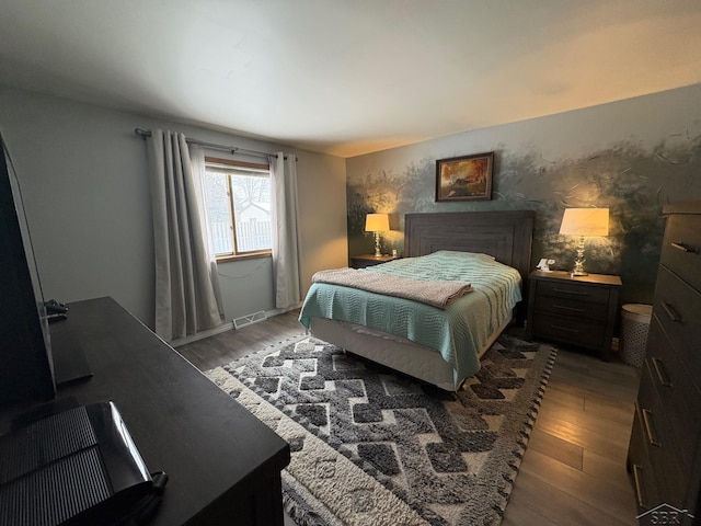 bedroom featuring visible vents and wood finished floors