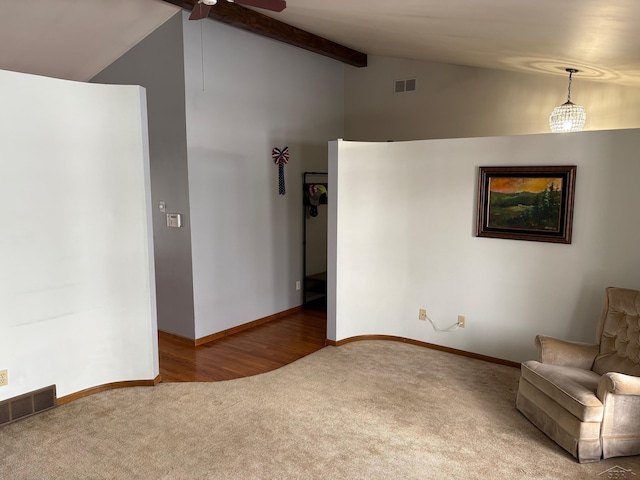 unfurnished room featuring lofted ceiling with beams, carpet floors, visible vents, and baseboards