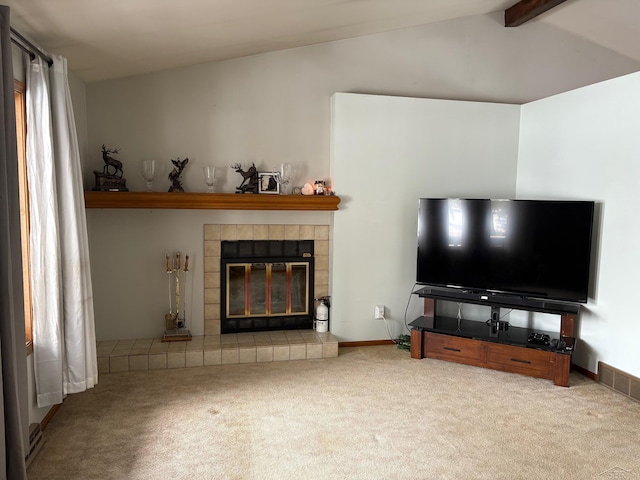 carpeted living room with lofted ceiling with beams, a tiled fireplace, visible vents, and baseboards