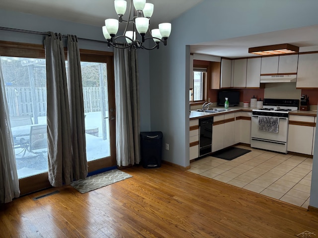 kitchen with light countertops, white cabinetry, white range with gas cooktop, dishwasher, and under cabinet range hood