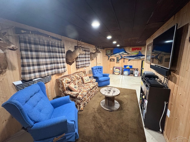 living area featuring wooden walls and recessed lighting