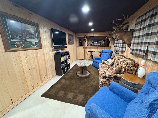 living room with recessed lighting and wooden walls