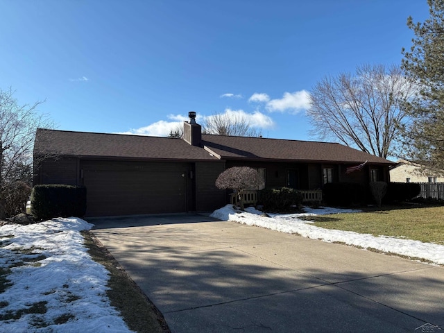 single story home featuring a porch, concrete driveway, a chimney, and an attached garage