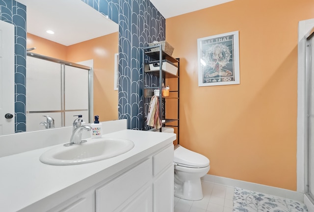 bathroom featuring tile patterned flooring, toilet, vanity, baseboards, and a stall shower