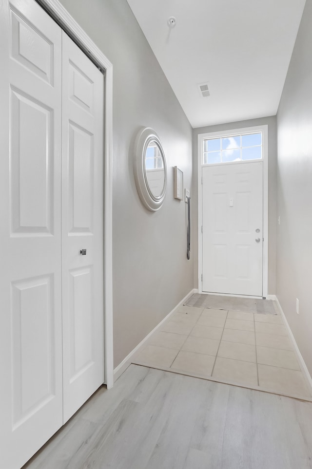 doorway to outside featuring visible vents and baseboards