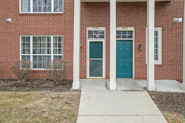 property entrance featuring brick siding