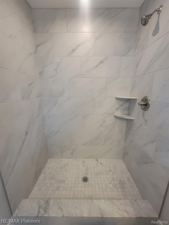 bathroom with tiled shower