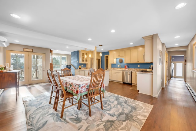 dining room featuring a baseboard heating unit, recessed lighting, baseboards, and wood finished floors