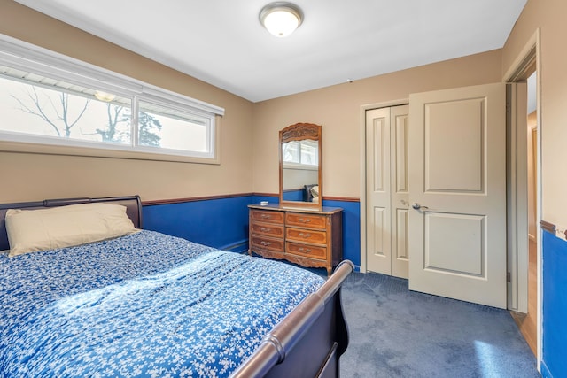 bedroom featuring dark colored carpet and a closet