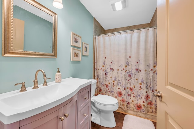 bathroom with toilet, wood finished floors, a shower with shower curtain, and vanity