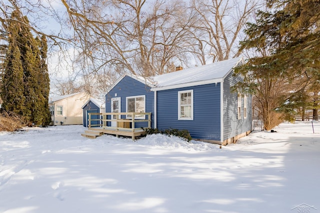 bungalow-style house with a chimney and a wooden deck