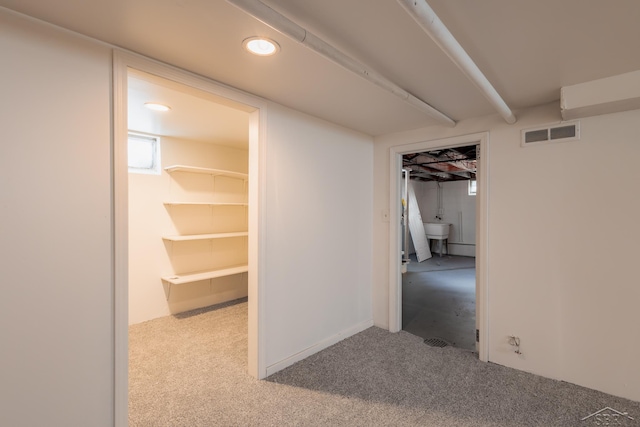 hallway with recessed lighting, visible vents, and light colored carpet