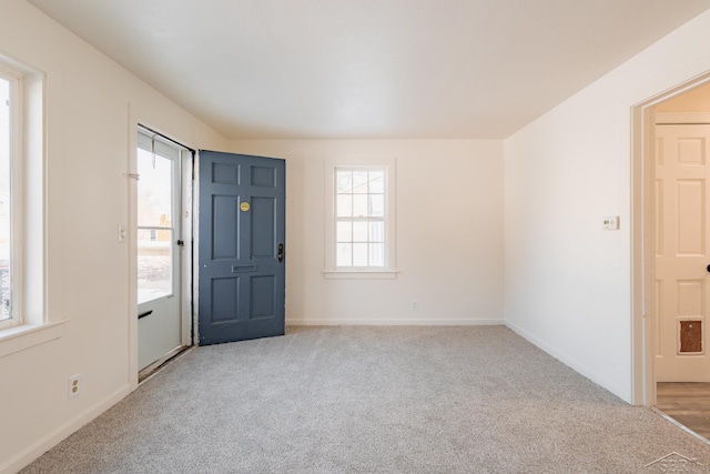 foyer with light colored carpet and baseboards