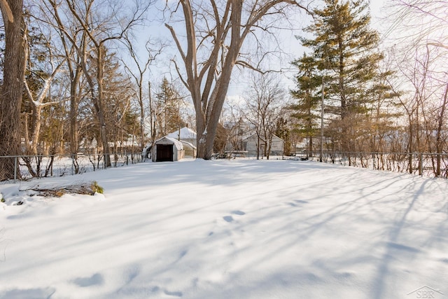 yard covered in snow with a detached garage