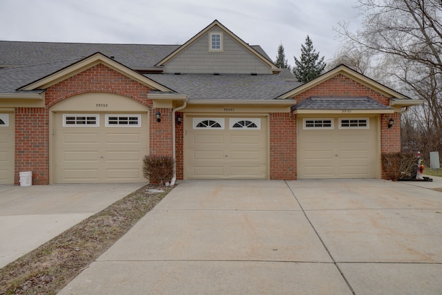 view of front of home with brick siding and roof with shingles