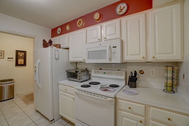 kitchen with a toaster, light countertops, light tile patterned floors, decorative backsplash, and white appliances