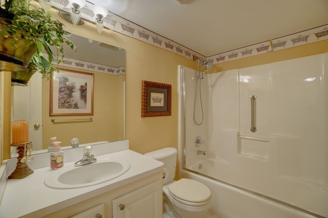 bathroom with bathing tub / shower combination, toilet, and vanity