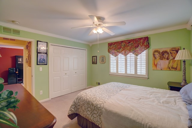 bedroom featuring visible vents, carpet floors, a closet, and crown molding