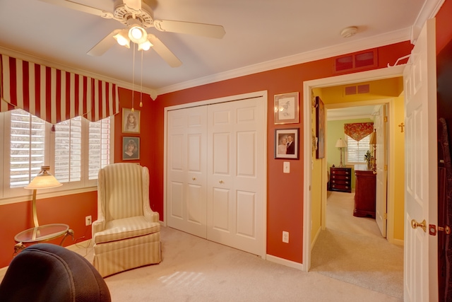 living area featuring crown molding, visible vents, a wealth of natural light, and carpet floors