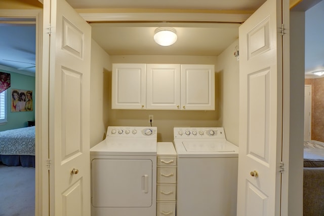 laundry room with carpet flooring, cabinet space, and washer and dryer