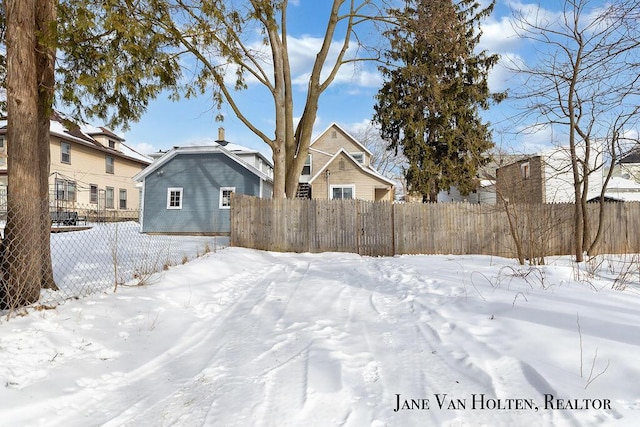 yard covered in snow with fence