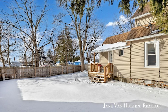 yard layered in snow with fence