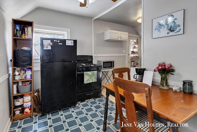 kitchen featuring ceiling fan, lofted ceiling, baseboards, white cabinets, and black appliances