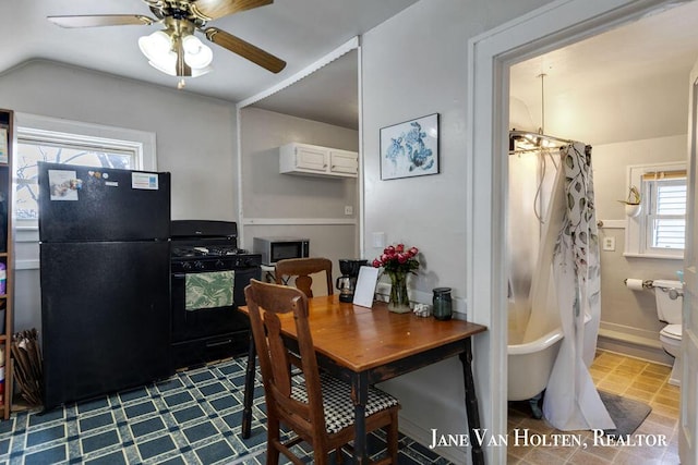 dining space featuring baseboards and ceiling fan with notable chandelier