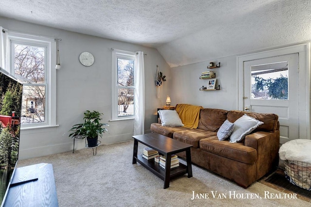 living area featuring lofted ceiling, light colored carpet, a textured ceiling, and baseboards