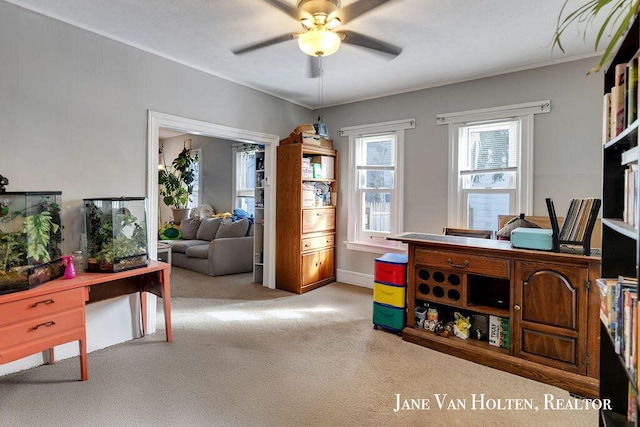 office area featuring light carpet and a ceiling fan