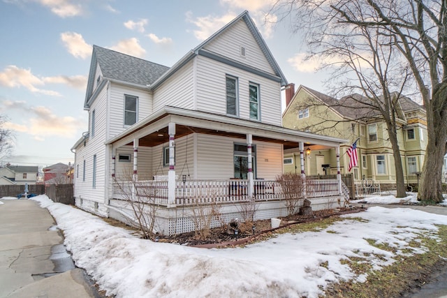 view of front of home with covered porch and a shingled roof