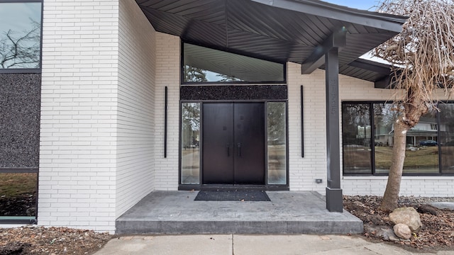 property entrance with brick siding