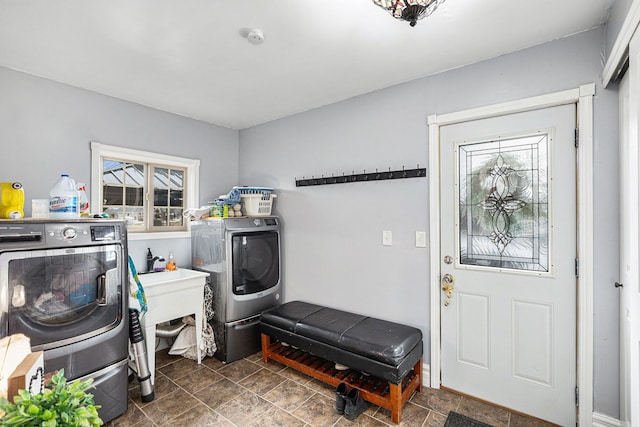 3342 Oak Grove Rd, Howell, MI 48855 - laundry room featuring independent washer and dryer, laundry area, stone finish floor, and a healthy amount of sunlight