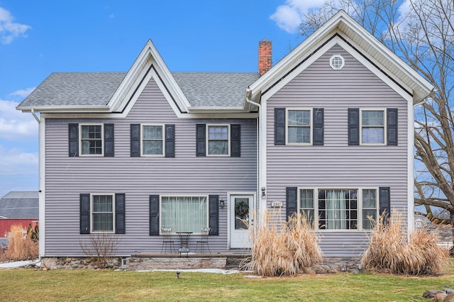 3342 Oak Grove Rd, Howell, MI 48855 - view of front facade featuring a chimney, a shingled roof, and a front yard