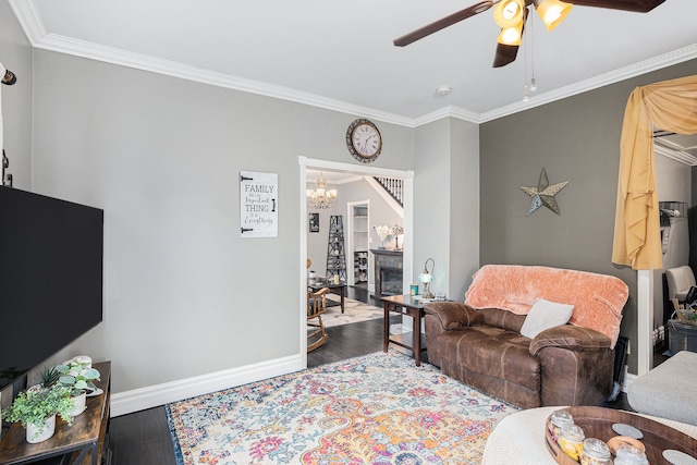 3342 Oak Grove Rd, Howell, MI 48855 - living area with baseboards, ornamental molding, ceiling fan with notable chandelier, and wood finished floors