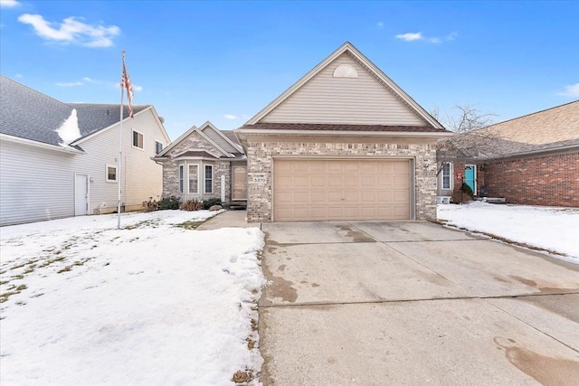 view of front of home with driveway, a garage, and brick siding