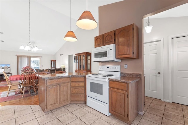 kitchen featuring light tile patterned floors, white appliances, open floor plan, brown cabinets, and decorative light fixtures