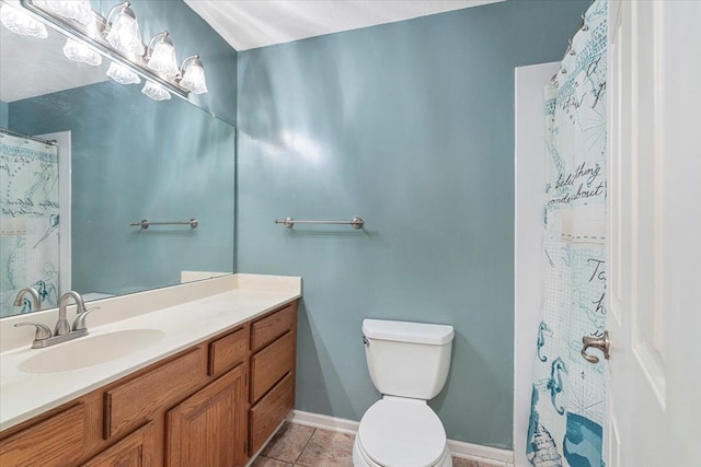 full bathroom with toilet, baseboards, vanity, and tile patterned floors