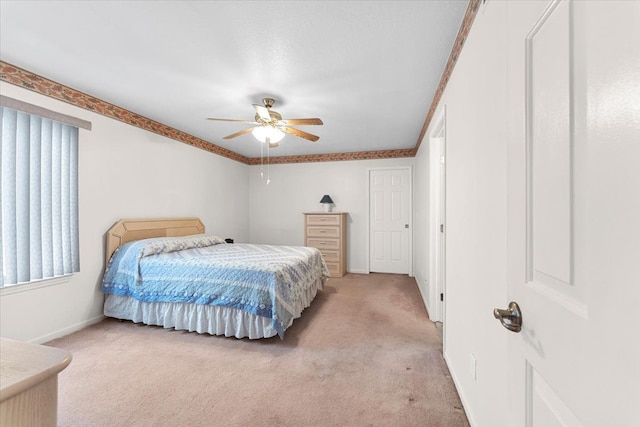 bedroom featuring light carpet, ceiling fan, and baseboards