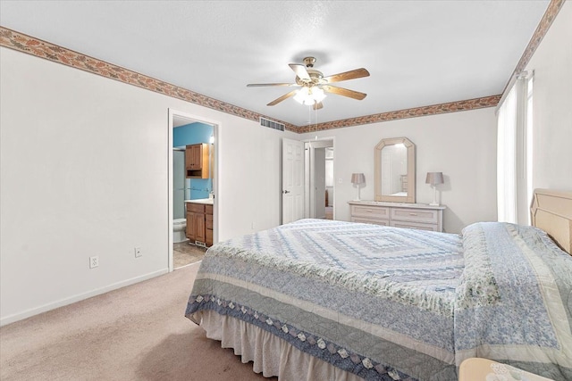 bedroom featuring baseboards, visible vents, light colored carpet, ceiling fan, and ensuite bathroom