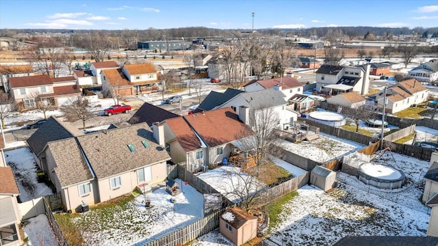 snowy aerial view with a residential view