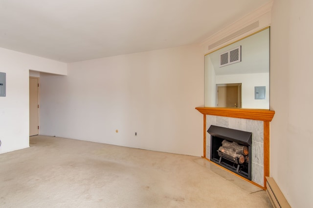 unfurnished living room with carpet floors, a baseboard radiator, visible vents, a tile fireplace, and electric panel