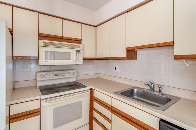 kitchen featuring light countertops, white appliances, a sink, and tasteful backsplash