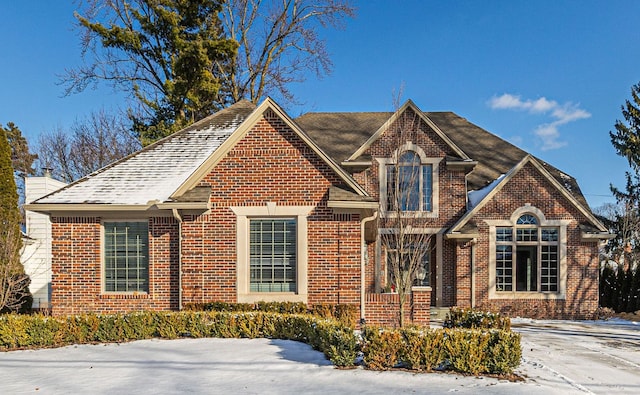 traditional-style house with brick siding and a chimney