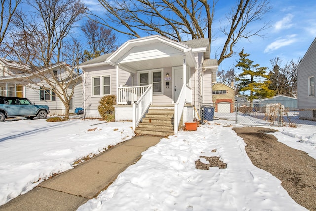 bungalow featuring a porch, fence, and a gate