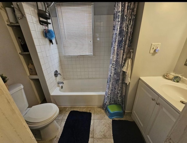 full bath with toilet, shower / tub combo, vanity, and tile patterned floors