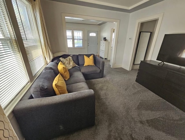 carpeted living area with baseboards